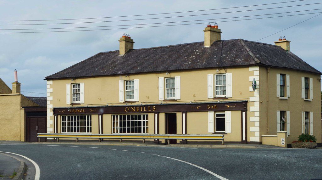 O'Neill's in Castledermot: a long cream two-storey building on a bend in the road